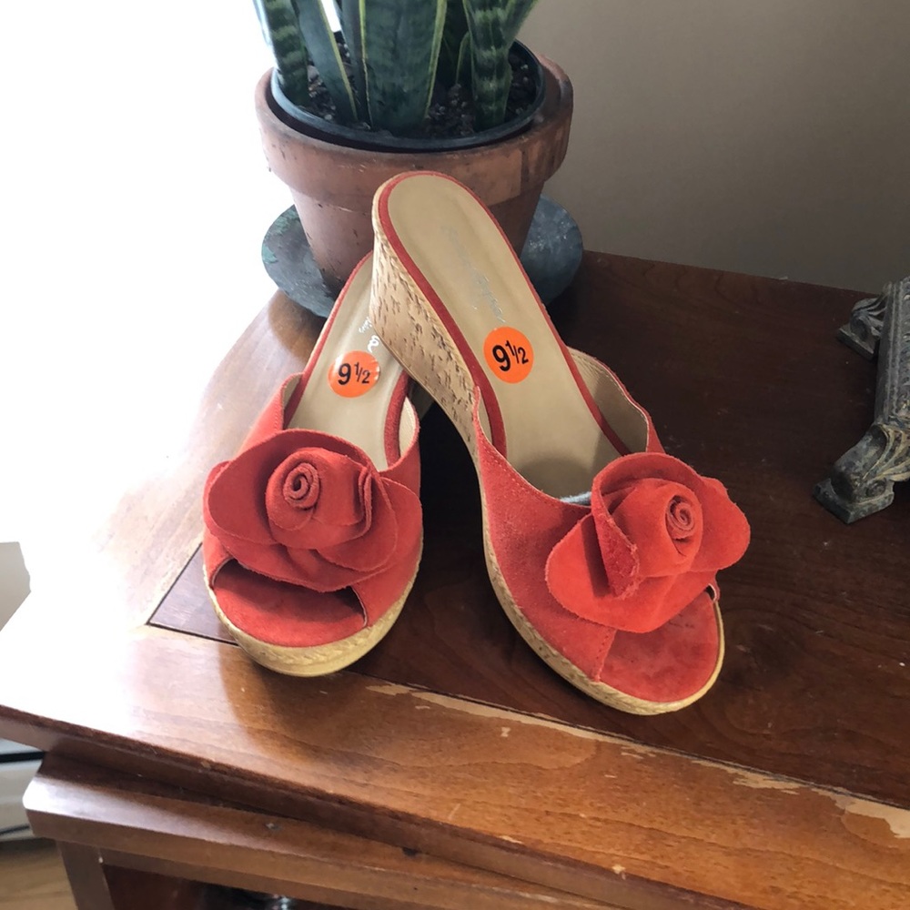 Orange suede slip on cork soled clogs.